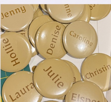 Personalised cream badges with guests' names for a wedding